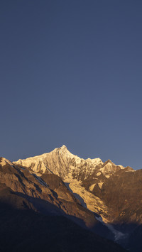 The Meili Snow Mountain is dazzling with golden light