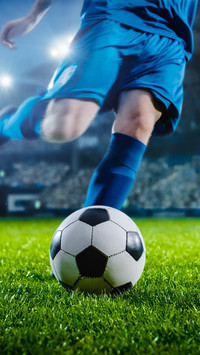 Soccer Player Runs to Kick the Ball