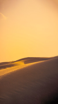 Sand dune during sunset with silhouette