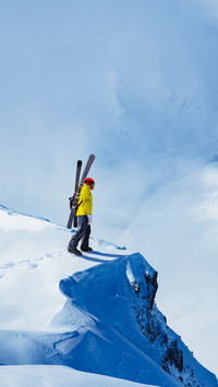 Adult man stand on the mountain top cliff with backpack