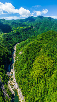 The yanzihe gorge is shrouded in mist and clouds
