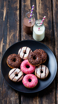 Two glass bottles of milk and cocoa and plate of