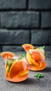 Grapefruit and rosemary infused water on dark