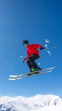 A Skier Jumps over a Mountain Skiing