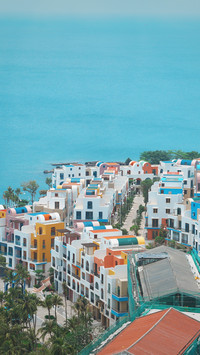 A group of seaside apartments with white walls and