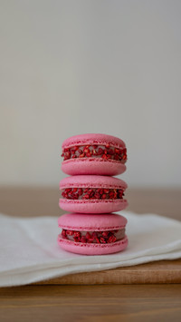 Three macaroons on a wooden background