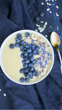 Pineapple smoothie bowl with blueberries and cashew nuts