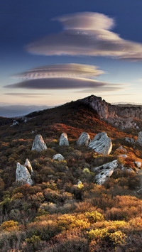 UFO-like clouds upon hills