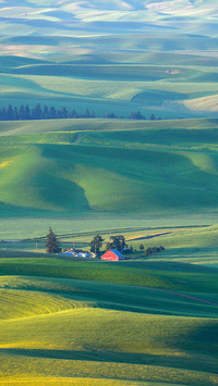 Red barn with hill in farm land in washington