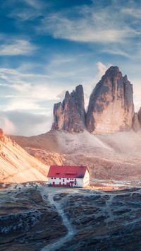 House in mountain valley at autumn sunset