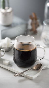 Black coffee on shallow depth of field grey background