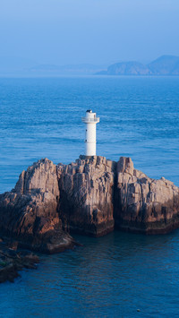 The lighthouse under the setting sun