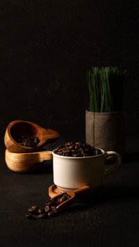 coffee beans that are poured in a glass with the addition