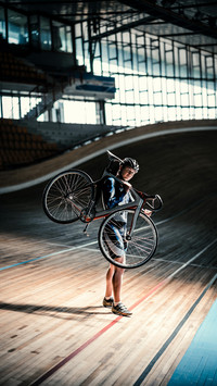 A Sportsman is Carrying a Bicycle