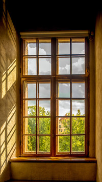 An old window where the shadows play on the wall