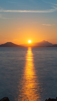 The setting suns ripples shatter into golden shadows