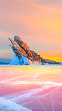 In winter Baikal lake with transparent cracked blue ice