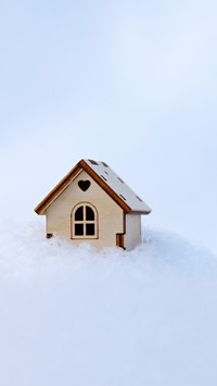 Wooden house model in a snow