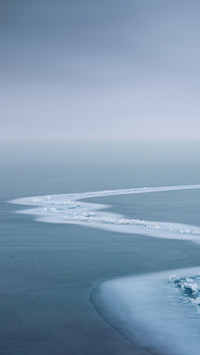 Backpackers are traveling alone on the lake surface of