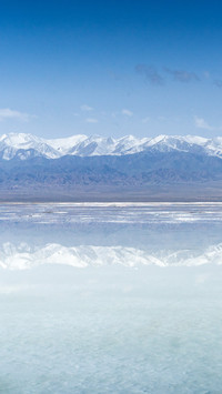 Reflection of snow-capped mountains in Chaka Salt Lake