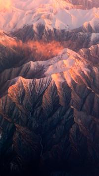 Aircraft Flying over Snowy Mountains