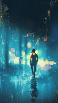 Man walking at night on the wet street