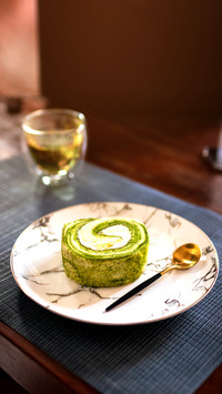 Sponge cake rolled with fresh cream on vintage plate