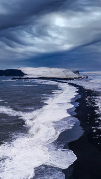 The huge waves on the black sand beach