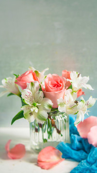 Peach Roses and White Alstroemeria arranged in a clear vase