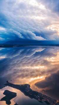 Cumulus clouds reflected in the sea view