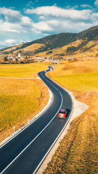 Aerial View of the Road in Mountain Valley at Sunset