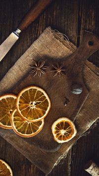 Dried oranges and spices on a wooned board