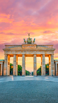 Brandenburg gate illuminated at sunset in Berlin