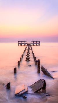 The old pier is in a decayed condition in the morning light