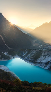 Mountain valley and turquoise lake at sunrise in Nepal