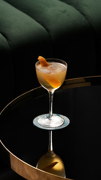 Fresh cocktail glass on glass table in restaurant