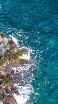 The waves crashing against the rocks