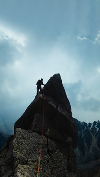Man climber looking for adventure on top of the mountain