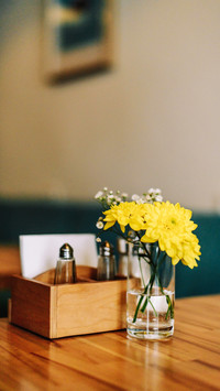 Still life flowers in a vase on a table in a coffee shop