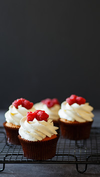 Cupcakes with cream and raspberries minimalism