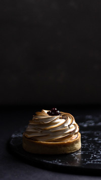 Delicious mini lemon tart with white cream and berries