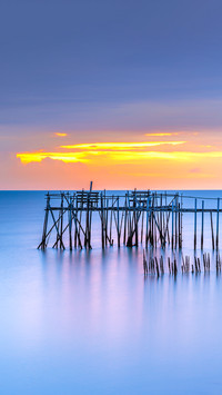 A sunset view of wooden fishermen jetty with nets