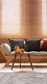 Black and striped pillows on beige living room sofa