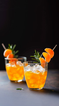 Alcoholic cocktail with mandarins and rosemary