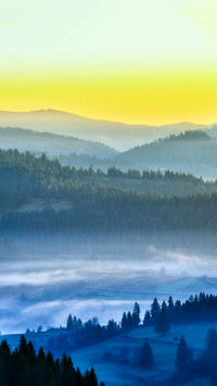 Clouds and mist surround the mountains