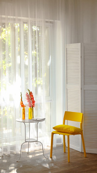 Yellow chair in a room with flowers