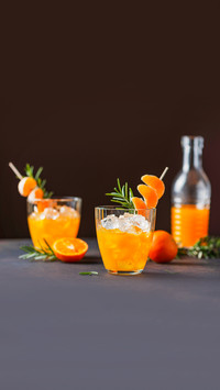 Alcoholic cocktail with mandarins and rosemary