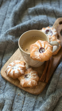 Biscuit chip cookies with jam and cup of coffee on wool knit
