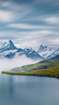 Early morning winter pasture snow capped mountains