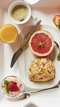 Tray with homemade rhubarb scones strawberry butter